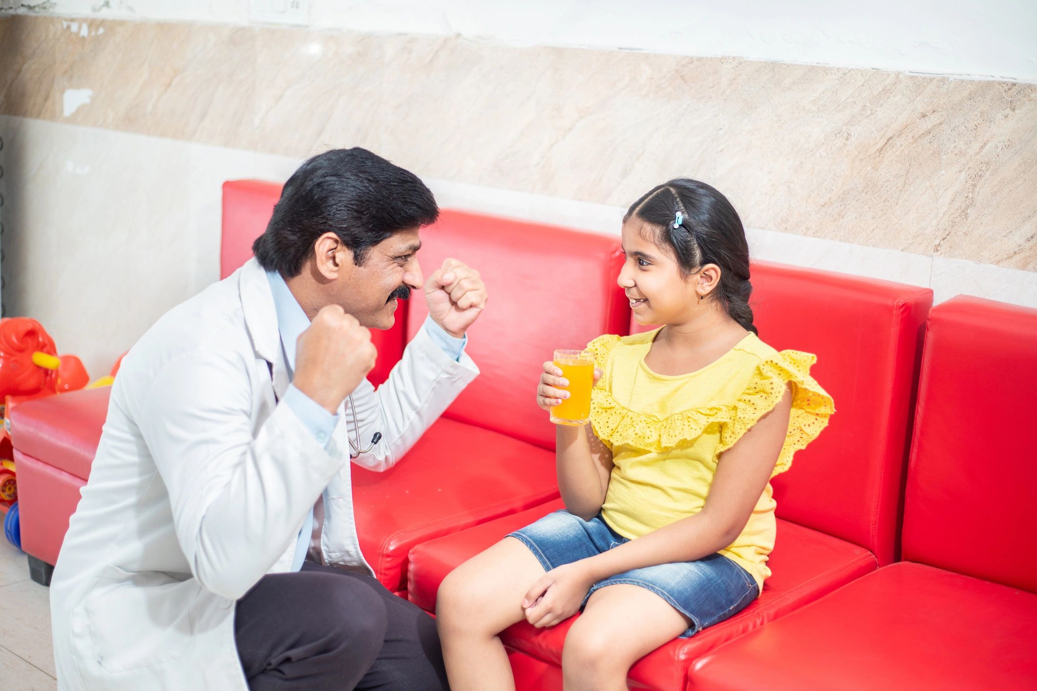 Clinician supporting a child during a speech therapy visit